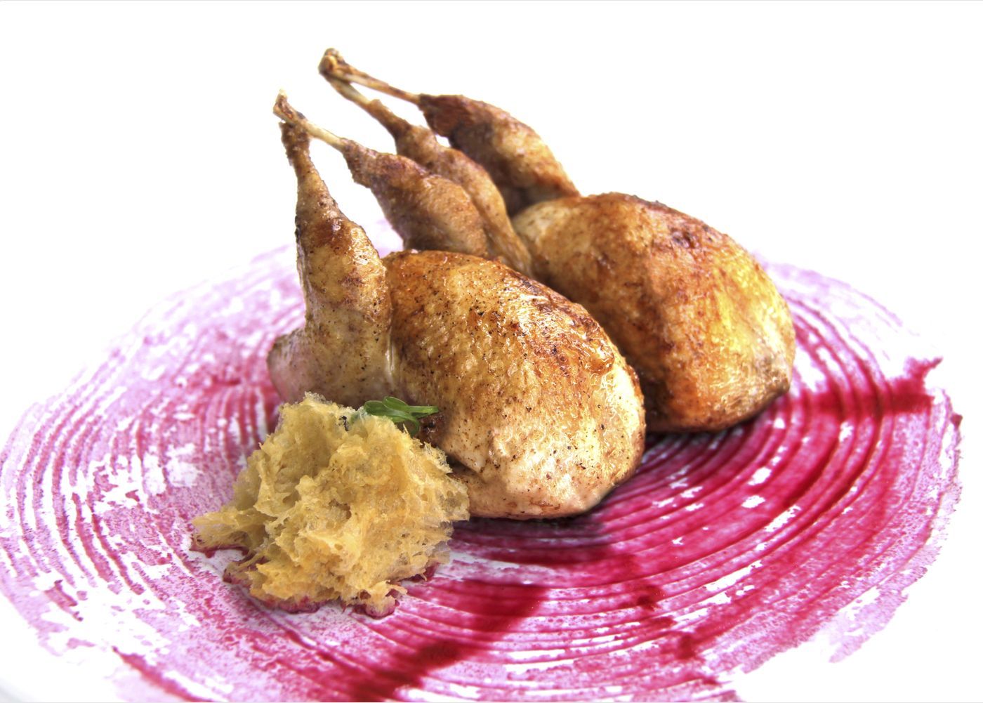 Roasted whole quail on a red beet sauce