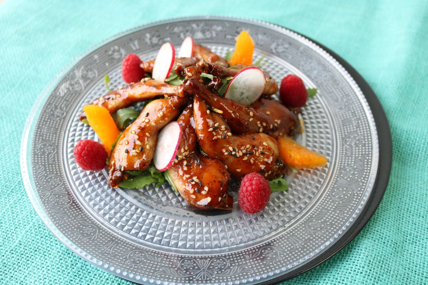 Glazed quail with sesame, raspberries, and orange